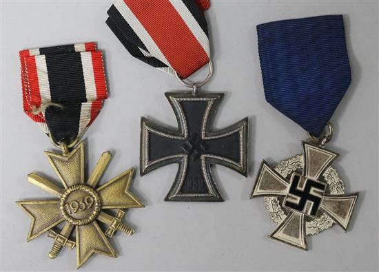 A German Iron Cross, 2nd class German Merit cross with swords German Faithful service medal